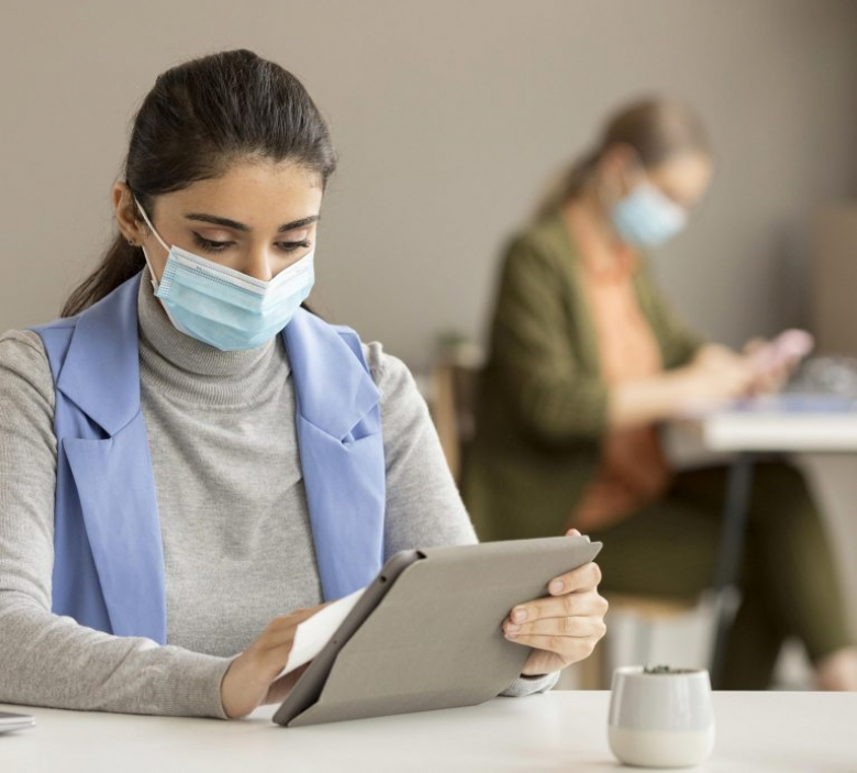 employee-disinfecting-electronic-device-768x692